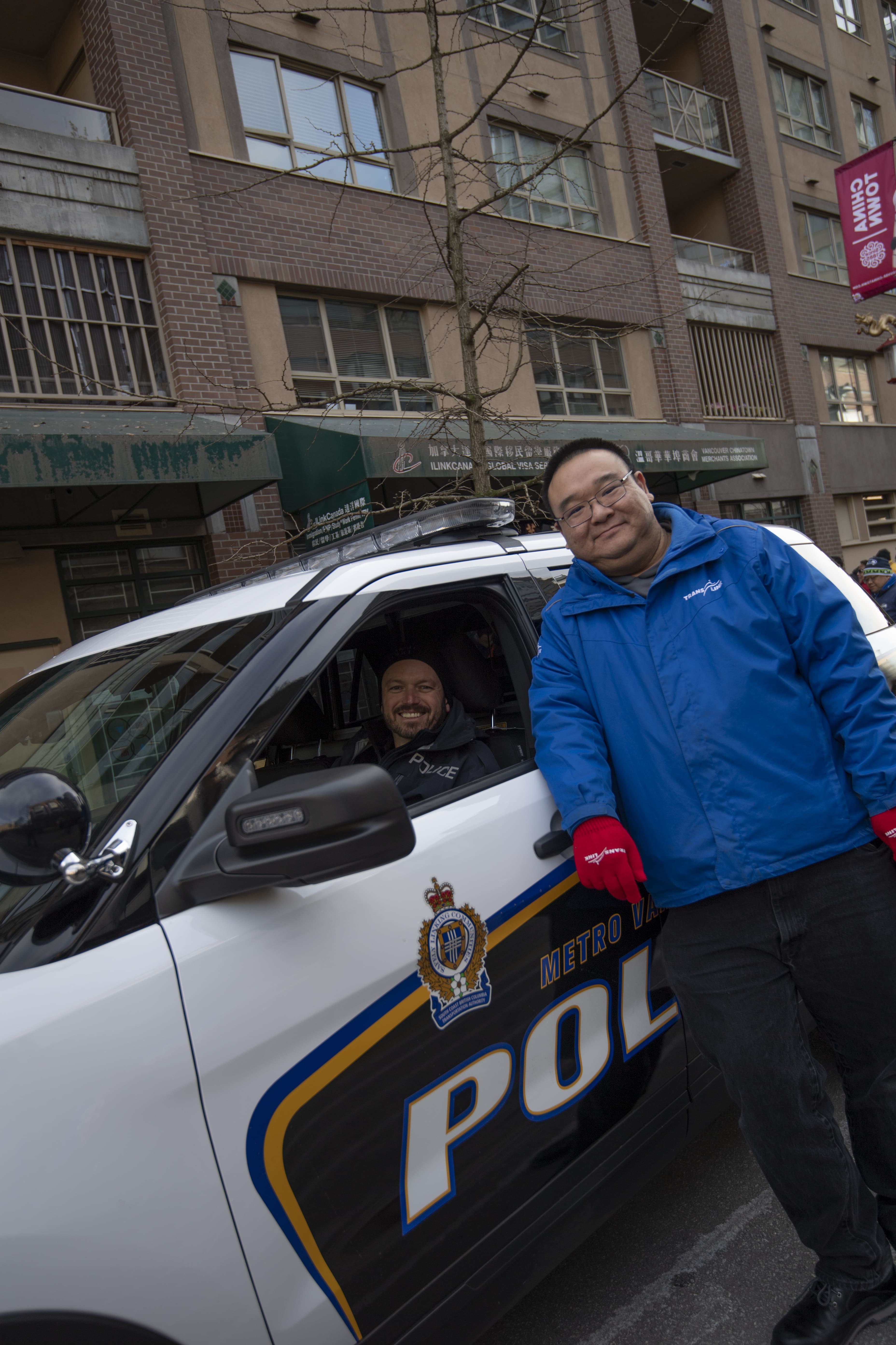 A TransLink representative and Transit Police posing for Lunar New Years