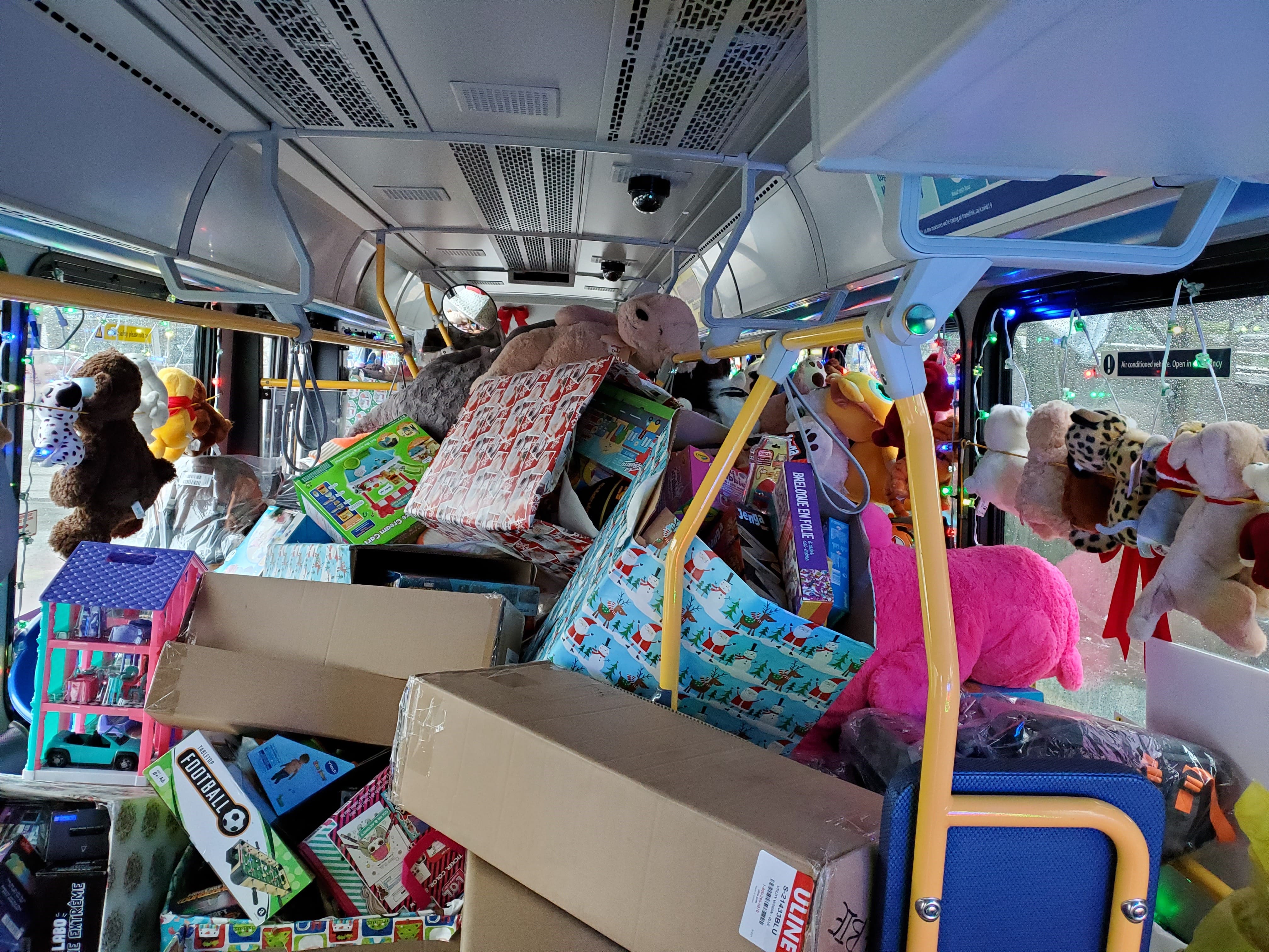The inside of a bus full of wrapped toys
