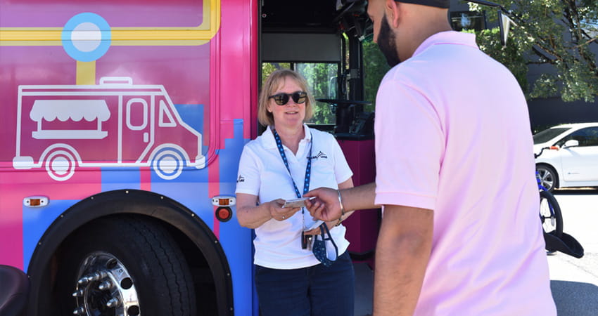 A volunteer showing a customer a transit map