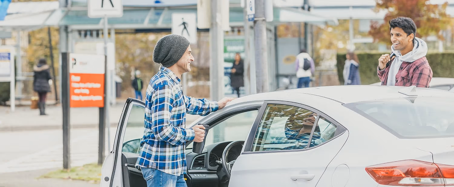 Two men getting out of a parked car