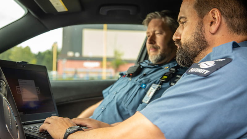 Transit Security Officer operating a laptop from the interior of his vehicle