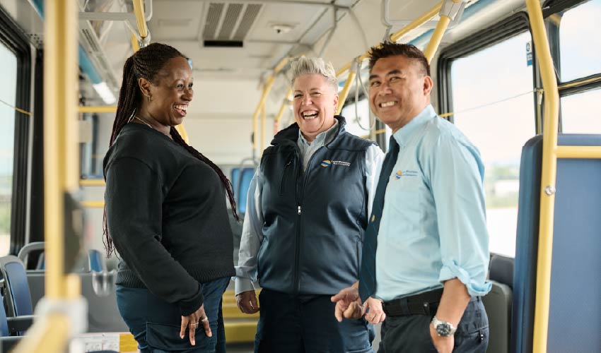 Three bus operators inside a bus