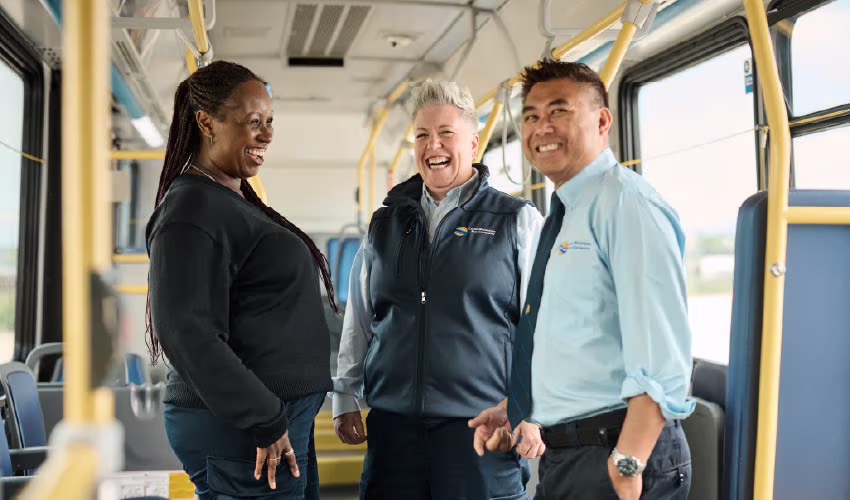 Three bus operators inside a bus