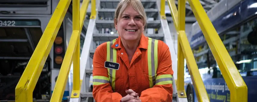 CMBC mechanic smiling while sitting on stairs