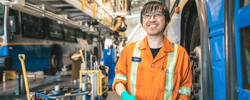 CMBC Partsperson smiling inside bus maintenance centre