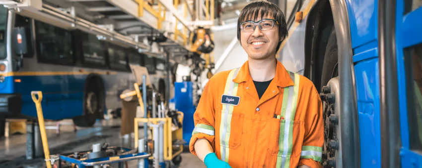 CMBC Partsperson smiling inside bus maintenance centre