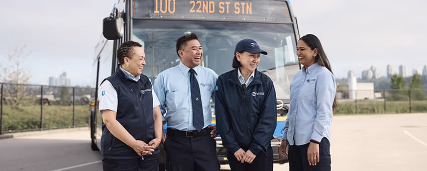 Four bus operators smiling