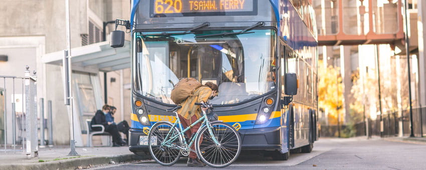 Passenger loading their bike onto the front of a bus at Bridgeport Station