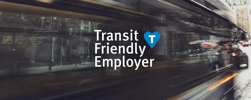 motion blur photo of a bus passing by with the Transit Friendly Logo overlaid