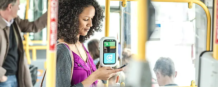 Passenger using the TransLink website on the bus
