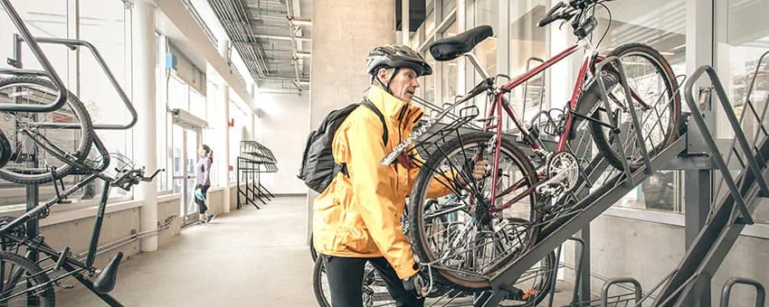 A cyclist picking up his bike from the bike parkade