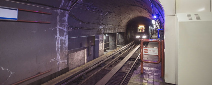 SkyTrain travelling through Dunsmuir tunnel with track in foreground