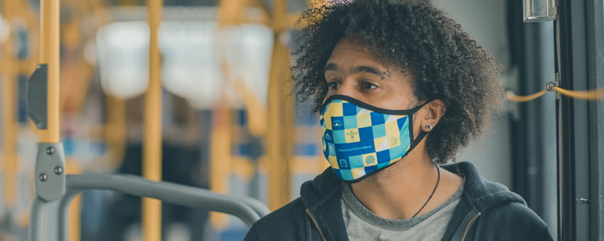 Man wearing a mask while riding the bus