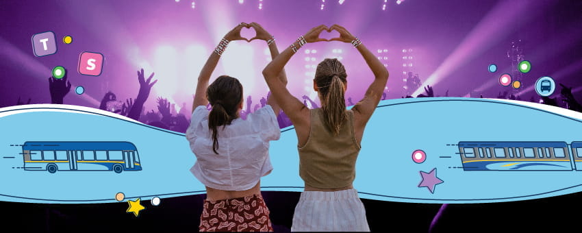 Two concertgoers making heart signs with their hands while at a show