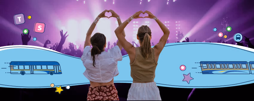 Two concertgoers making heart signs with their hands while at a show
