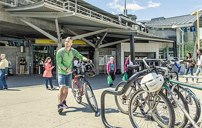 Man leaving SkyTrain station with a bike