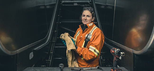 Female technician repairing an escalator at a skytrain station