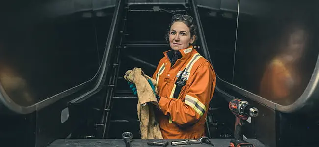 Female technician repairing an escalator at a skytrain station