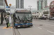 A bus picking up passengers at a bus stop
