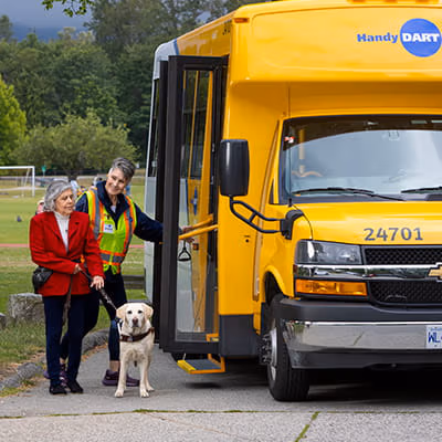 HandyDART bus parked while a passenger exits with support