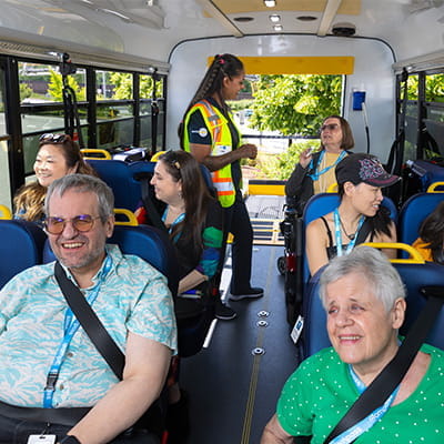Passengers seated inside a HandyDART with driver nearby