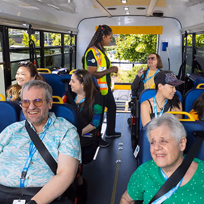 Passengers seated inside a HandyDART with driver nearby