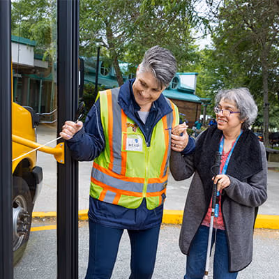 Driver assisting a passenger enter a HandyDART