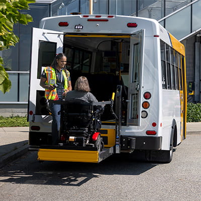 Wheelchair user boarding a HandyDART using a lift