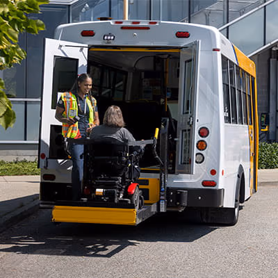 Wheelchair user boarding a HandyDART using a lift