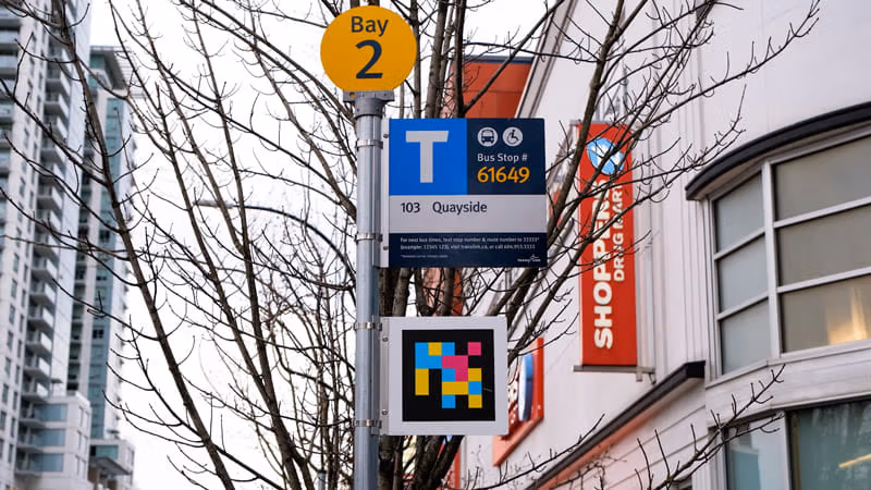Accessible Navigation code sign on bus stop pole in New Westminster
