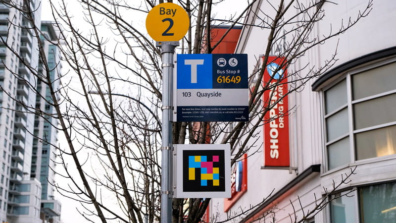 Accessible Navigation code sign on bus stop pole in New Westminster