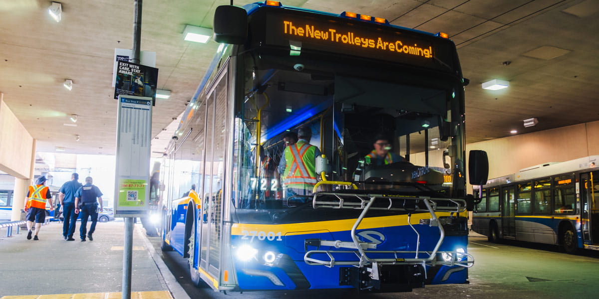 Solaris trolleybus parked at Metrotown bus loop with the words "The new trolleys are coming!"
