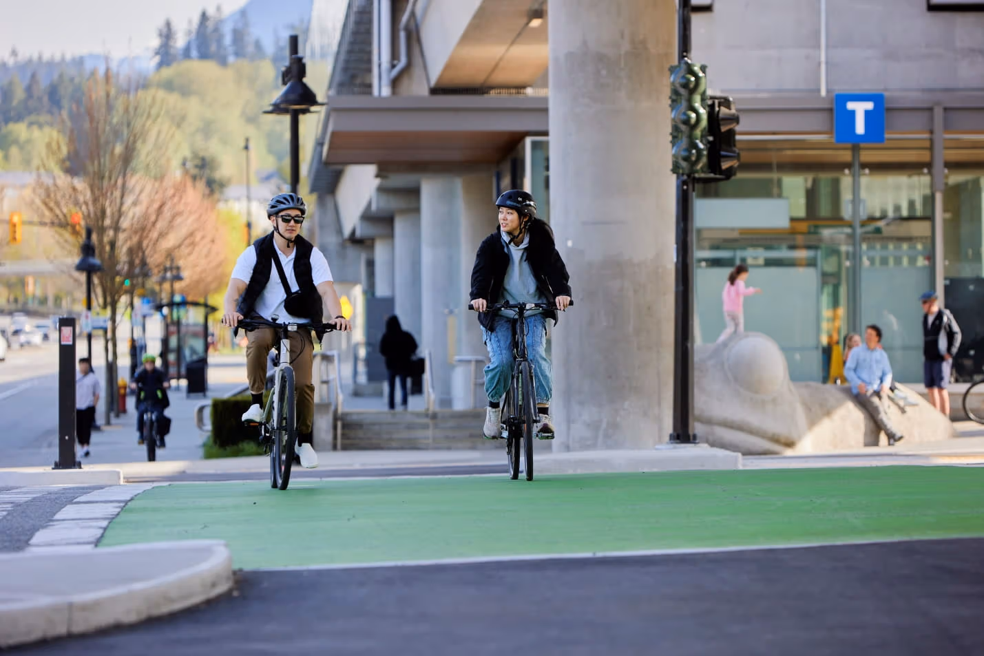 Two people cycling beside each other
