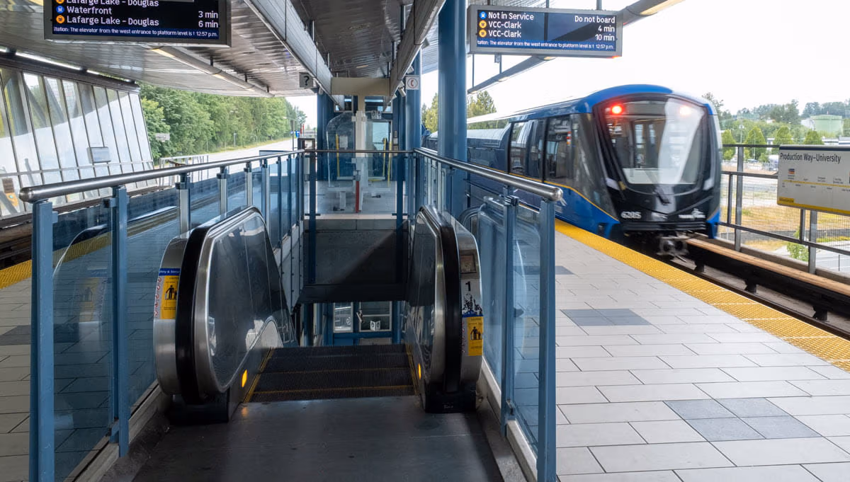 Escalator at Production Way-University Station with MKV on outbound platform