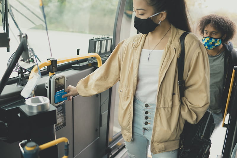 Masked customers boarding a bus