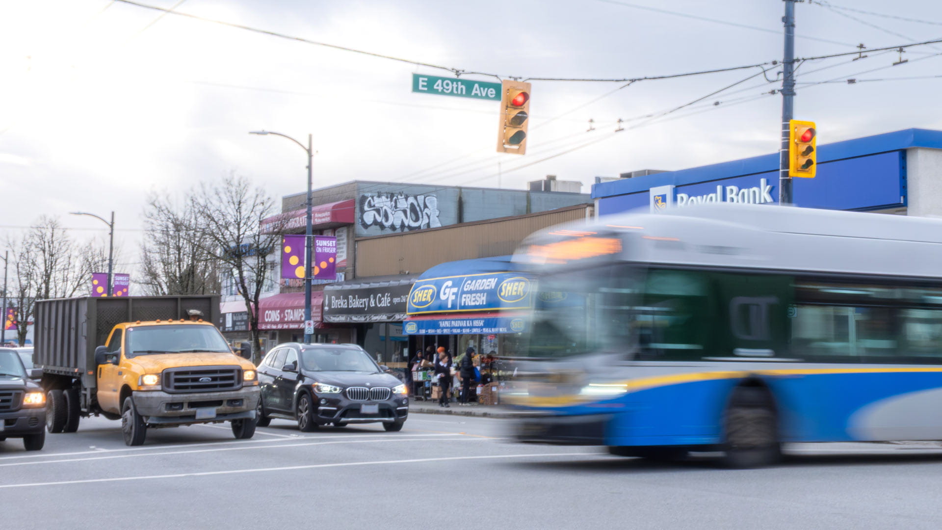 Bus crossing eastbound 49th Ave at Fraser while northbound traffic waits
