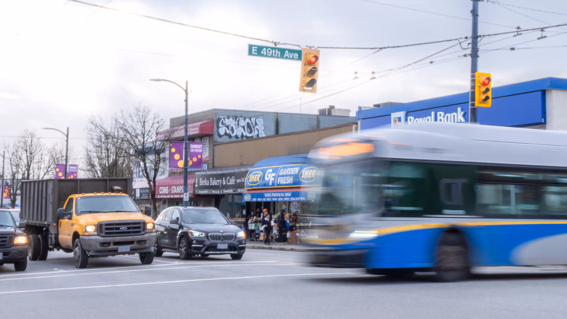 Bus crossing eastbound 49th Ave at Fraser while northbound traffic waits