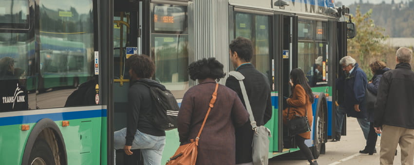 Passengers boarding on a bus from the back door