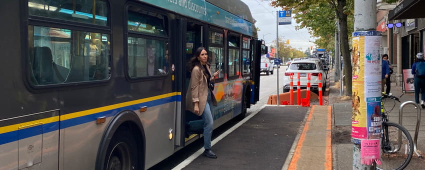 Passenger getting off from the bus at a bus stop