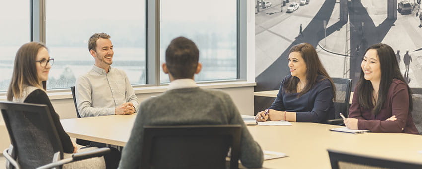 A group of individuals engaged in a meeting at the TransLink office
