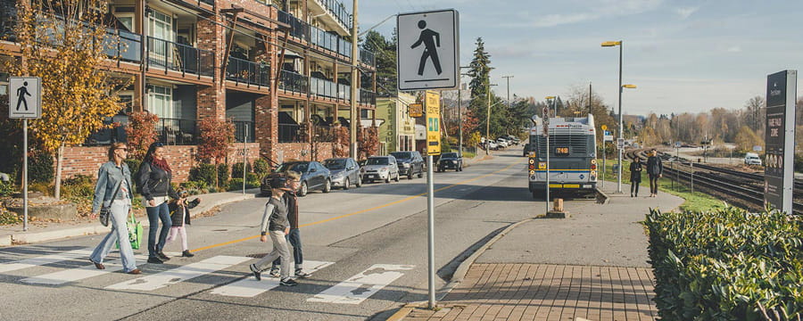 People crossing an empty street.