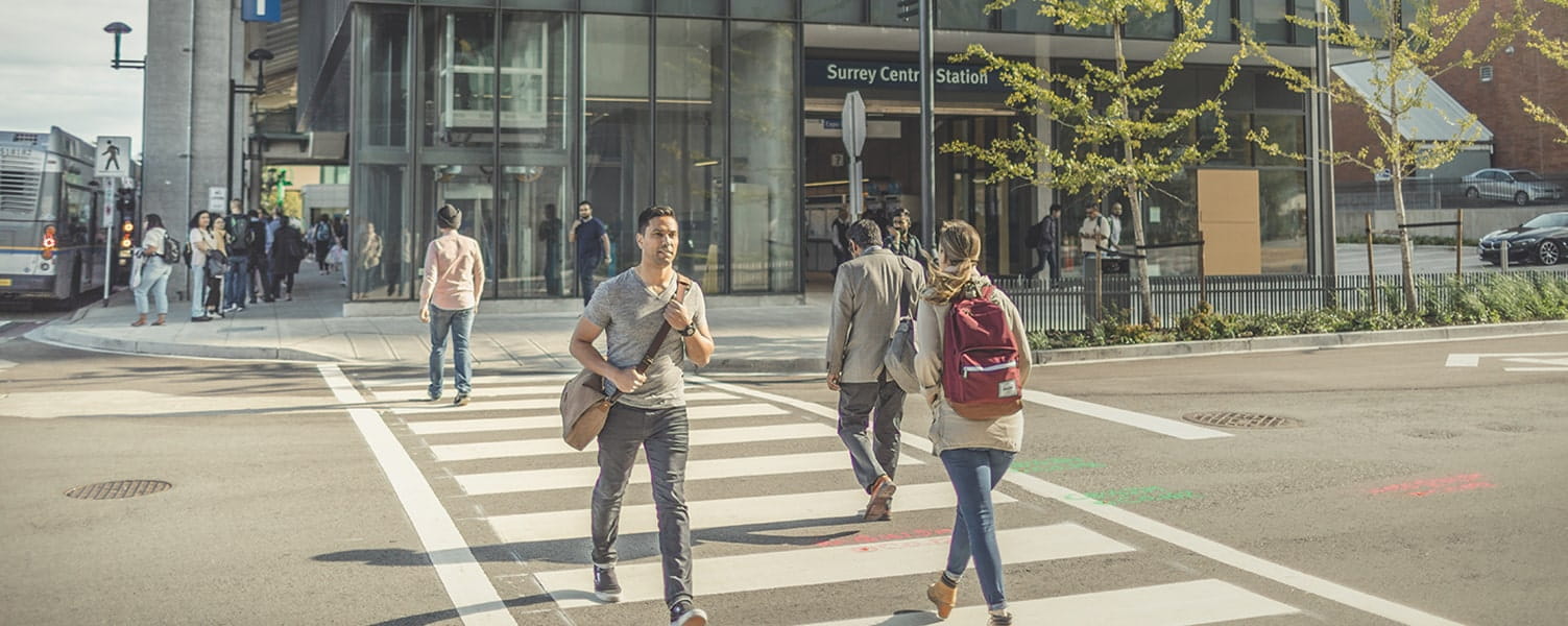 People walking outside a newly-renovated SkyTrain station
