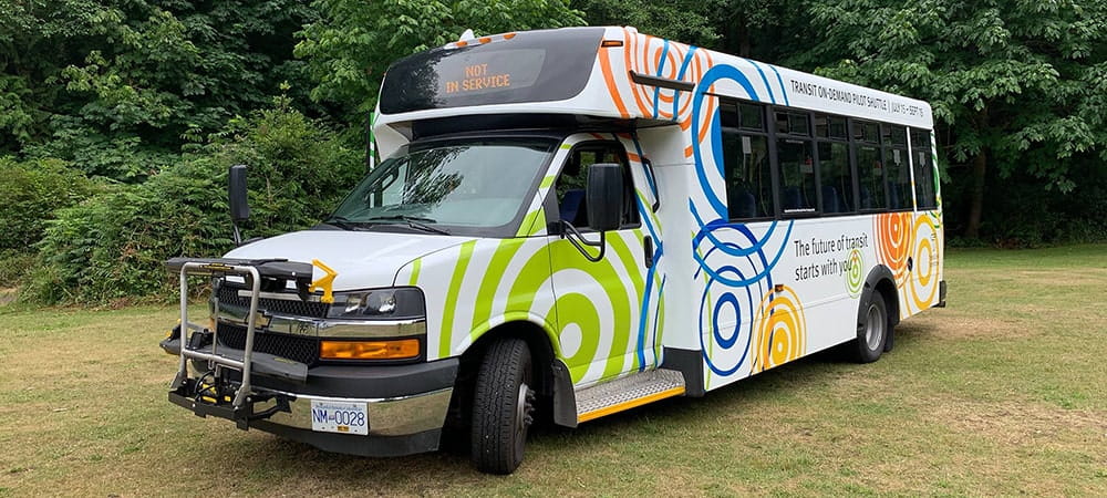 A multi-coloured shuttle bus seen outside in Bowen Island