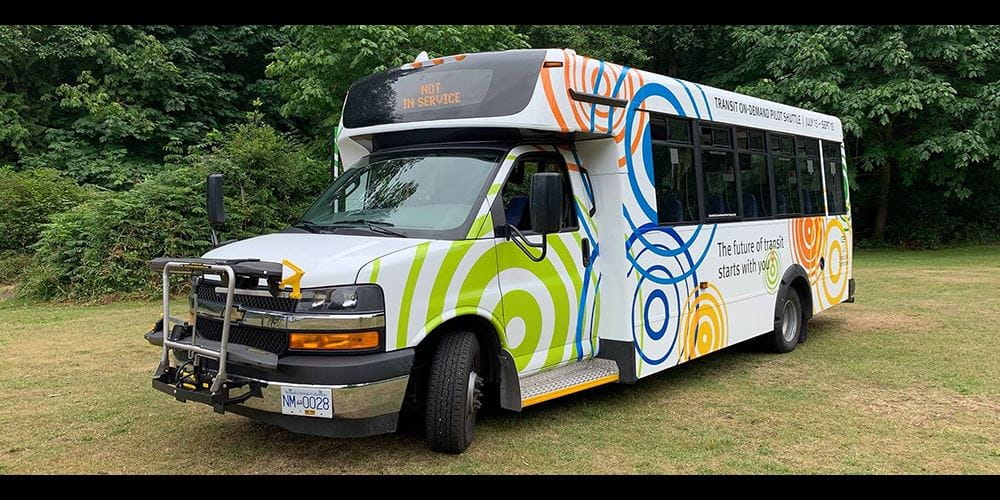 A multi-coloured shuttle bus seen outside in Bowen Island