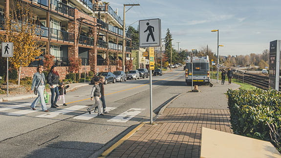 Pedestrians that include mothers and children crossing the street