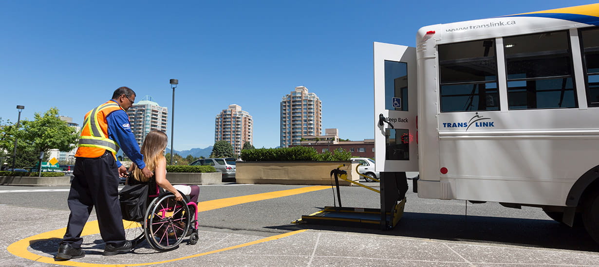 Woman in wheelchair boarding a HandyDART bus