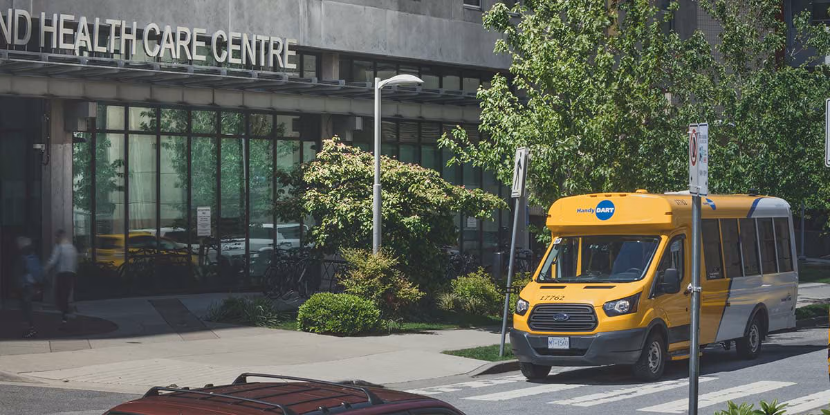 A HandyDART Parked outside a Health Centre waiting for a passenger