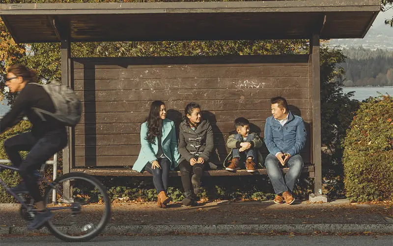 A family of four waiting for the bus in Kitsilano
