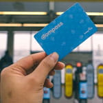 a Compass Card being held up in front of fare gates