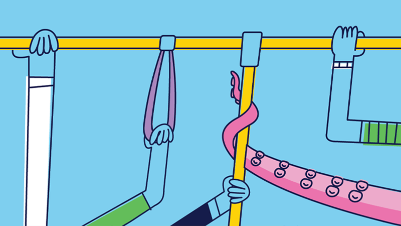 Various hands holding safety handles inside a moving transit vehicle